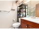 Bathroom featuring vanity, toilet, and open shelving for storage at 4636 S Dillon Ct # B, Aurora, CO 80015