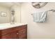 Bathroom featuring a vanity with dark wood cabinets, a mirror, and a decorative shelf at 4636 S Dillon Ct # B, Aurora, CO 80015