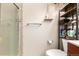 Bathroom with glass enclosed shower, open shelving, and modern fixtures at 4636 S Dillon Ct # B, Aurora, CO 80015
