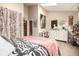Bedroom with a bed and a white dresser complemented by a sunburst mirror at 4636 S Dillon Ct # B, Aurora, CO 80015