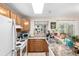 Functional kitchen featuring wooden cabinets, a white refrigerator, and a window with plants at 4636 S Dillon Ct # B, Aurora, CO 80015