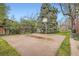 Private basketball court surrounded by mature trees and landscaping at 835 Niagara St, Denver, CO 80220