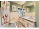 Bathroom featuring a clawfoot tub, wainscoting, and granite countertops at 835 Niagara St, Denver, CO 80220
