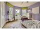 Bedroom with purple walls, white trim, and three windows for ample light at 835 Niagara St, Denver, CO 80220