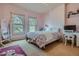 Bedroom with hardwood floors, two large windows, and a desk area at 835 Niagara St, Denver, CO 80220