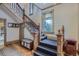 Elegant foyer featuring a staircase with decorative wood banisters, a stained glass window, and hardwood floors at 835 Niagara St, Denver, CO 80220
