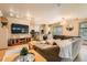 Open-concept living room flows into a modern kitchen and features hardwood floors at 835 Niagara St, Denver, CO 80220