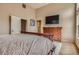 Bedroom featuring bed, dresser, TV, and art work at 835 Niagara St, Denver, CO 80220