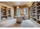 Spacious office with built-in shelves, large round table, and natural light from two windows at 835 Niagara St, Denver, CO 80220