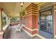 Inviting front porch with seating area and vintage architectural details at 835 Niagara St, Denver, CO 80220