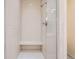 Shower stall featuring white subway tile, glass door, and built-in bench at 835 Niagara St, Denver, CO 80220