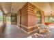 Cozy wraparound porch featuring wood flooring, ample seating, and views of the surrounding yard at 835 Niagara St, Denver, CO 80220