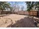 Large backyard with a wood fence, garden bed, and a few trees at 4942 W 9Th Ave, Denver, CO 80204