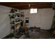 Unfinished basement with exposed ceiling and foundation walls, and shelving at 4942 W 9Th Ave, Denver, CO 80204