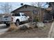 Exterior view of a home with a white pickup truck parked in the driveway at 4942 W 9Th Ave, Denver, CO 80204