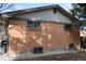 Exterior view displaying brick siding, secure window coverings and the side of the home at 4942 W 9Th Ave, Denver, CO 80204