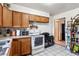 View of the kitchen, which features wood cabinetry and tiled flooring at 4942 W 9Th Ave, Denver, CO 80204