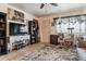 Cozy living area showcasing the entrance door, a neutral rug, and a wall-mounted TV at 4942 W 9Th Ave, Denver, CO 80204