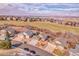 Aerial view of a neighborhood near a golf course and rolling hills at 1339 Bent Grass Cir, Castle Rock, CO 80109