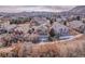 Backyard view of a residential home with a partially covered deck and mountain views in the distance at 1339 Bent Grass Cir, Castle Rock, CO 80109