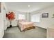 Bright bedroom with a simple bed, two windows, a modern interior design, and natural light at 1339 Bent Grass Cir, Castle Rock, CO 80109