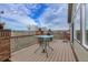 Spacious wooden deck with brick pillars, views, and outdoor seating area at 1339 Bent Grass Cir, Castle Rock, CO 80109