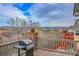 Back deck with a grill and views of the treeline and distant mountains at 1339 Bent Grass Cir, Castle Rock, CO 80109