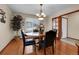 Bright dining room features hardwood floors, a round wood table, four chairs and an entry door at 1339 Bent Grass Cir, Castle Rock, CO 80109