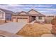 Well-maintained ranch-style home featuring a three-car garage and a beautifully landscaped front yard at 1339 Bent Grass Cir, Castle Rock, CO 80109