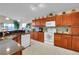 Spacious kitchen with wood cabinetry, granite countertops, and modern appliances for seamless cooking at 1339 Bent Grass Cir, Castle Rock, CO 80109