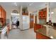 Spacious kitchen featuring wood cabinets, granite counters, and a view into the dining area at 1339 Bent Grass Cir, Castle Rock, CO 80109