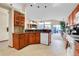 Bright kitchen featuring wood cabinets, a breakfast bar, and an open layout perfect for entertaining at 1339 Bent Grass Cir, Castle Rock, CO 80109
