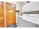 Laundry room with a white washer and dryer set, cabinets, key rack, and an exterior door at 1339 Bent Grass Cir, Castle Rock, CO 80109