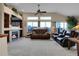 Open living room with a fireplace, vaulted ceilings, large windows and mountain views at 1339 Bent Grass Cir, Castle Rock, CO 80109