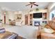 Open living room with fireplace, television, and stairs to another level at 1339 Bent Grass Cir, Castle Rock, CO 80109