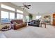 Open living room with a vaulted ceiling and large windows providing natural light and views at 1339 Bent Grass Cir, Castle Rock, CO 80109