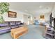 Open living room with a large leather couch, a wet bar, blue chairs, and recessed lighting at 1339 Bent Grass Cir, Castle Rock, CO 80109