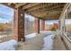 Covered patio with brick columns and a view of the trees at 1339 Bent Grass Cir, Castle Rock, CO 80109