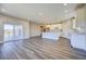 Open-concept living area connecting to the kitchen, featuring wood-look floors and a sliding glass door at 17220 Snowwood Dr, Monument, CO 80132