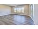 Bright living room with wood floors, recessed lighting, large windows and a sliding glass door to the outside at 17220 Snowwood Dr, Monument, CO 80132