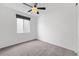 Bedroom with carpet, ceiling fan, and a window for natural light at 18129 E 99 Pl, Commerce City, CO 80022