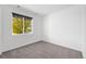 Well-lit bedroom with plush carpet, a large window, and neutral wall color at 18129 E 99 Pl, Commerce City, CO 80022