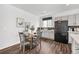 Cozy dining area with a round table, seating for four, and view of modern kitchen finishes at 18129 E 99 Pl, Commerce City, CO 80022