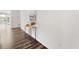 Modern hallway with hardwood floors, a console table, and natural light at 18129 E 99 Pl, Commerce City, CO 80022