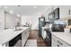 Bright kitchen with stainless steel appliances, island, and a view of the dining area at 18129 E 99 Pl, Commerce City, CO 80022