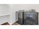 Laundry area with modern washer and dryer units next to shelving space at 18129 E 99 Pl, Commerce City, CO 80022