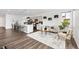 Spacious and bright open-concept living space featuring kitchen, dining, and living room areas at 18129 E 99 Pl, Commerce City, CO 80022