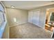 Carpeted bedroom featuring a double door closet and window at 1243 Gaylord St # 302, Denver, CO 80206