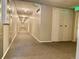 Long hallway featuring neutral tones, lighting and carpet flooring in a condominium complex at 1243 Gaylord St # 302, Denver, CO 80206