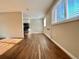 Open-concept living space featuring hardwood floors, ample natural light, and a view into the kitchen at 1243 Gaylord St # 302, Denver, CO 80206